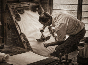 Man stretching parchment